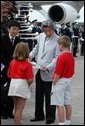 Arriving for the G8 summit at Sea Island, Ga., Japanese Prime Minister Junichiro Koizumi talks with children at Hunter Army Airfield in Savannah, Ga., June 8, 2004. White House photo by Paul Morse