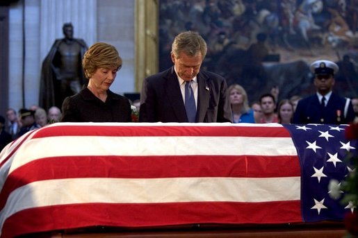 President George W. Bush and Laura Bush pay their final respects at the casket containing the body of former President Ronald Reagan in the U.S. Capitol Rotunda, Thursday, June 10, 2004. White House photo by Eric Draper.