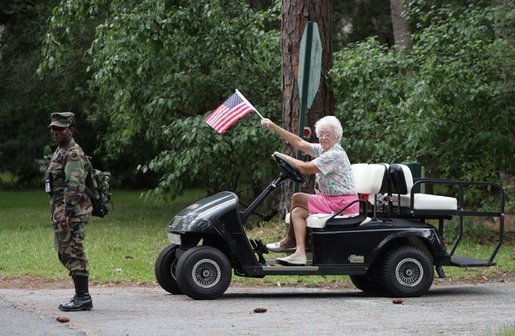 A women waves an American flag at the G8 Summit on Sea Island, Ga., Wednesday, June 9, 2004. White House photo by Eric Draper.
