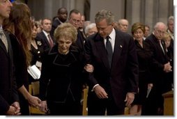 President George W. Bush escorts former First Lady Nancy Reagan to her seat before the funeral service for former President Ronald Reagan at the National Cathedral in Washington, DC on June 11, 2004.  White House photo by Paul Morse