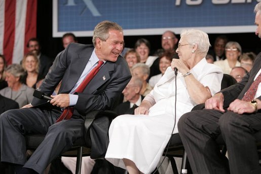 President George W. Bush laughs with senior Wanda Blackmore during a conversation on Medicare-approved prescription drug discount cards in Liberty, Mo., June 14, 2004. White House photo by Paul Morse