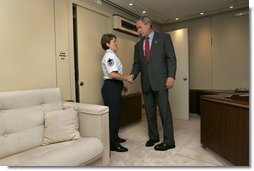 President George W. Bush meets Freedom Corps Greeter Master Sergeant Gina Carnesecchi aboard Air Force One after arriving at MacDill Air Force Base in Tampa, Florida, Wednesday, June 16, 2004. Sgt. Carnesecchi founded Operation Lighthouse, a program at MacDill AFB to support troops who are deployed overseas.  White House photo by Eric Draper