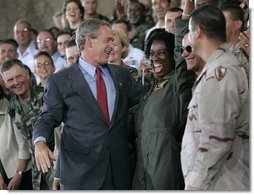 President George W. Bush greets stage participants after delivering remarks to military personnel at MacDill Air Force Base in Tampa, Florida, Wednesday, June 16, 2004.   White House photo by Eric Draper