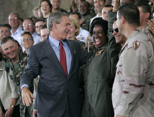 President George W. Bush greets stage participants after delivering remarks to military personnel at MacDill Air Force Base in Tampa, Florida, Wednesday, June 16, 2004. White House photo by Eric Draper.