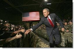 President George W. Bush greets Fort Lewis military personnel in the audience during his introduction at Fort Lewis, Washington, Friday, June 18, 2004.  White House photo by Eric Draper