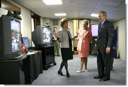 President George W. Bush views a demonstration of broadband and wireless technologies at the U.S. Department of Commerce Thursday, June 24, 2004.