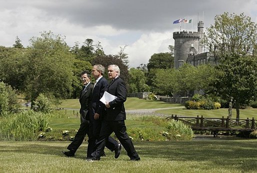 President George W. Bush walks with Prime Minister of Ireland Bertie Ahern, right, and President of the European Commission Romano Prodi on the way to their joint press conference at the Dromoland Castle in Shannon, Ireland, Saturday, June 26, 2004. White House photo by Eric Draper