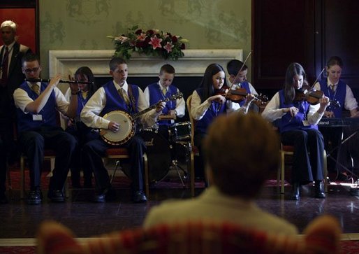 Children play traditional Irish music for Laura Bush during a performance at Dromoland Castle in Shannon, Ireland, Saturday, June 26, 2004. White House photo by Joyce Naltchayan