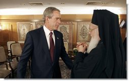 President George W. Bush talks with Ecumenical Patriarch Bartholomew I after meeting with religious leaders in Istanbul, Turkey, Sunday, June 27, 2004.  White House photo by Eric Draper