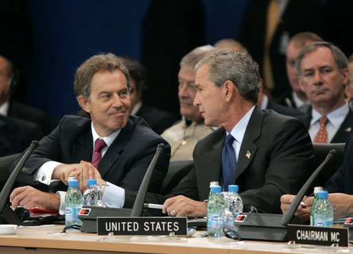 Minutes after the Coalition Provisional Authority transferred authority to Iraq's interim government, President George W. Bush and British Prime Minister Tony Blair shake hands during a work session at the NATO Summit in Istanbul, Turkey, Monday, June 28, 2004. White House photo by Eric Draper.