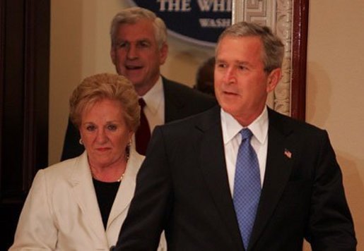President George W. Bush enters with Sally and Senator John Danforth before the swearing-in ceremony for Senator Danforth as the new representative of the United States to the United Nations in the Eisenhower Executive Office Building on July 1, 2004. White House photo by Paul Morse