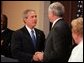 President George W. Bush congratulates Senator John Danforth as the new representative of the United States to the United Nations after a swearing-in ceremony in the Eisenhower Executive Office Building on July 1, 2004. White House photo by Paul Morse