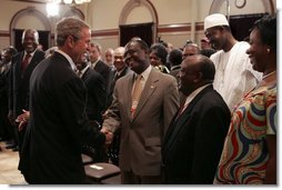 After signing into law the African Growth and Opportunity Act (AGOA) Acceleration Act of 2004, President George W. Bush meets with ceremony attendees in the Dwight D. Eisenhower Executive Office Building Tuesday, July 13, 2004.  White House photo by Paul Morse