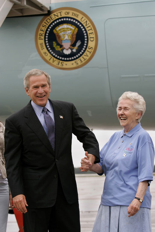 President George W. Bush meets USA Freedom Corps Greeter Grace McCarthy, 83, upon his arrival in Marquette, Mich., Tuesday, July 13, 2004. Ms. McCarthy has volunteered more than 4,000 hours with local groups, including the Retired and Senior Volunteer Program in Marquette. White House photo by Eric Draper