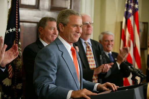 President George W. Bush is applauded during his remarks at the signing ceremony for the Identity Theft Penalty Enhancement Act in the Roosevelt Room of the White House Thursday, July 15, 2004. "The Identity Theft Penalty Enhancement Act also prescribes prison sentences for those who use identity theft to commit other crimes, including terrorism. It reflects our government's resolve to answer serious offenses with serious penalties," said the President. White House photo by Paul Morse