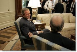 President George W. Bush and President Ricardo Lagos of Chile talk after meeting with the press in the Oval Office Monday, July 19, 2004.  White House photo by Paul Morse