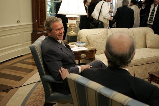 President George W. Bush and President Ricardo Lagos of Chile talk after meeting with the press in the Oval Office Monday, July 19, 2004. White House photo by Paul Morse.