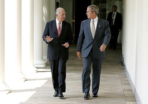 President George W. Bush and President Ricardo Lagos of Chile walk together along the colonnade at the White House Monday, July 19, 2004. White House photo by Paul Morse.