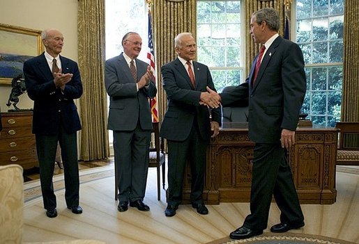 President George W. Bush welcomes Apollo 11 Astronauts Michael Collins, left, Neil Armstrong, center, and Buzz Aldrin to the Oval Office Wednesday, July 21, 2004. The astronauts visited the White House to mark the 35th anniversary of the successful Apollo 11 mission of landing on the moon, walking along its surface and safely returning home White House photo by Eric Draper.