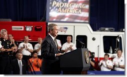 President George W. Bush receives applause during remarks on homeland security at Northeastern Illinois Public Training Academy in Glenview, Illinois on Thursday July 22, 2004.  White House photo by Paul Morse