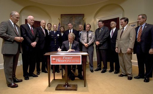 President George W. Bush signs H.R. 218, the Law Enforcement Officers Safety Act of 2004," which exempts qualified active and retired law enforcement officers from State laws that prohibit the carrying of concealed firearms, in the Roosevelt Room Thursday, July 22, 2004. White House photo by Tina Hager.