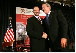 President George W. Bush greets Marc Morial, President of the National Urban League, after delivering his remarks in Detroit, Mich., Friday, July 23, 2004.  White House photo by Eric Draper
