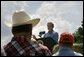 President George W. Bush talks about expanding the Conservation Reserve Program during a visit to the Katzenmeyer family farm in Le Sueur, Minn., Wednesday, Aug. 4, 2004. “I'm ordering the Secretary of Agriculture to help protect 250,000 acres of grasslands, which are the home of several species of birds, including the Northern Bobwhite Quail,” explained the President Bush. “By expanding this program, our goal is to increase the quail population by about 750,000 birds a year.” White House photo by Eric Draper.