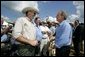 President George W. Bush talks with audience members at the Katzenmeyer family farm in Le Sueur, Minn., Wednesday, Aug. 4, 2004. White House photo by Eric Draper.