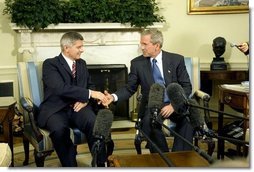 President George W. Bush and Prime Minister Marek Belka of Poland meet with the press in the Oval Office Monday, Aug. 9, 2004.  White House photo by Eric Draper