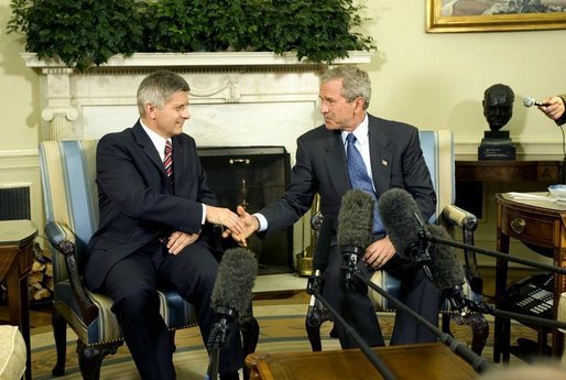 President George W. Bush and Prime Minister Marek Belka of Poland meet with the press in the Oval Office Monday, Aug. 9, 2004. White House photo by Eric Draper