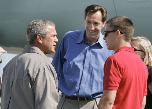 President George W. Bush meets Freedom Corps Greeter Chris Dudley, center, and Tyler Byrne, 17, at the Portland Air National Guard Base in Portland, Ore., Friday, Aug. 13, 2004. Mr. Dudley started The Dudley Foundation in 1994 to help children succeed regardless of economic, education, or health liabilities. One of the foundation's key projects is the creation of the first basketball camp for boys and girls with diabetes. Tyler takes part in the program. White House photo by Eric Draper.