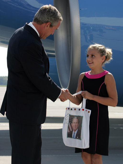 President George W. Bush visits with Freedom Corps greeter Alexandra Amend after arriving at Cincinnati/Northern kentucky International Airport Monday, Aug. 16, 2004. White House photo by Paul Morse.