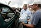 President George W. Bush helps to deliver water to a waiting motorist at an emergency relief center in Ft. Pierce, Fla., while touring relief efforts in response to Hurricane Frances damage, Wednesday, Sept. 8, 2004. White House photo by Eric Draper