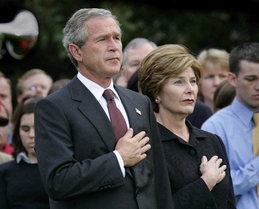 President George W. Bush and Mrs. Bush pause during the playing of Taps following the Moment of Silence on the South Lawn, Saturday, Sept. 11, 2004. White House photo by Eric Draper.