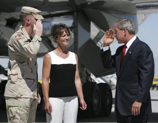 President George W. Bush returns the salute from National Guardsman Joshua Bunker while meeting his mother, Freedom Corps Greeter Theresa Bunker, at Las Vegas-McCarran International Airport, Sept. 14, 2004. White House photo by Eric Draper