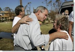 President George W. Bush comforts residents during a walking tour of neighborhoods damaged by Hurricane Ivan in Pensacola, Florida, Sunday, Sept. 19, 2004.  White House photo by Eric Draper