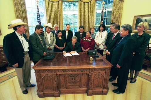 President George W. Bush signs an Executive Memorandum on Tribal Sovereignty and Consultation in honor of the opening of the National Museum of the American Indian, Thursday, Sept. 23, in the Oval Office. White House photo by Tina Hager