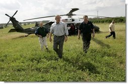 President George W. Bush and Governor Jeb Bush, right, arrive at Marty and Pat McKenna's orange grove to tour damage by the recent hurricanes in Lake Wales, Fla., Wednesday, Sept. 29, 2004.  White House photo by Eric Draper