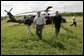 President George W. Bush and Governor Jeb Bush, right, arrive at Marty and Pat McKenna's orange grove to tour damage by the recent hurricanes in Lake Wales, Fla., Wednesday, Sept. 29, 2004. White House photo by Eric Draper.