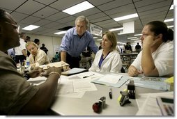 President George W. Bush visits with hurricane relief workers at Martin County Red Cross Headquarters in Stuart, Fla., Thursday, Sept. 30, 2004. "See, these volunteers show the true heart of America, because we're a compassionate people, we care when a neighbor hurts, we long to help somebody when help is needed," said the President. "They have the gratitude of all they've served, and they have the admiration for our whole country."  White House photo by Eric Draper
