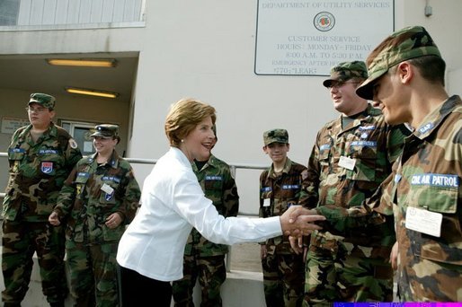 Laura Bush is greeted by members of the National Guard outside the Emergency Operations Center in Vero Beach, Fla., Friday, Oct. 1, 2004. White House photo by Joyce Naltchayan.