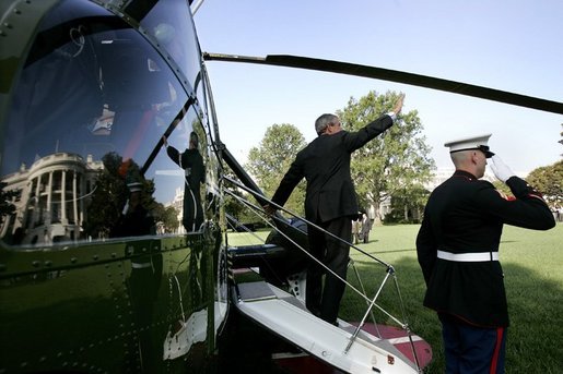 President George W. Bush waves from the steps of Marine One before departing the South Lawn Monday morning, Oct. 4, 2004. The President left for Des Moines, Iowa, to sign H.R. 1308, the Working Families Tax Relief Act of 2004. White House photo by Eric Draper