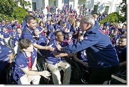 After addressing the athletes, President George W. Bush greets members of the 2004 U.S. Olympic and Paralympic Teams on the South Lawn Monday, Oct. 18, 2004.  White House photo by Tina Hager