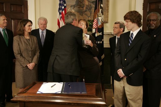 President George W. Bush hugs Sharon Smith, mother of Garret Smith, who committed suicide last year, during the signing ceremony of S. 2634, the Garrett Lee Smith Memorial Act, in the Roosevelt Room Thursday, Oct. 21, 2004. The act authorizes the spending of $82 million for youth suicide prevention programs at college campus mental health centers. Mrs. Smith is married to Sen. Gordon Smith, R-Ore. White House photo by Paul Morse