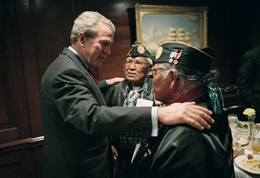 President George W. Bush talks with World War II Veterans Jose Ramos Chavez, left, and his younger brother Joe Diego Chavez, both of Albuquerque, N.M., during a breakfast with Secretary of Veterans Affairs Anthony Principi, Senator Bob Dole and World War II Veterans in the Executive Dining Room at the White House Friday, May 28, 2004. The brothers served in the Army during WWII. Jose took part in the D-Day invasion at Normandy, France, and Joe served in both the Atlantic and Pacific theaters. File photo. White House photo by Eric Draper.