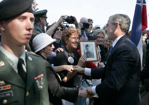 President George W. Bush meets with veterans and their families after delivering remarks during ceremonies marking the 60th anniversary of D-Day at the American Cemetery in Normandy, France, June 6, 2004. File Photo. White House photo by Eric Draper.