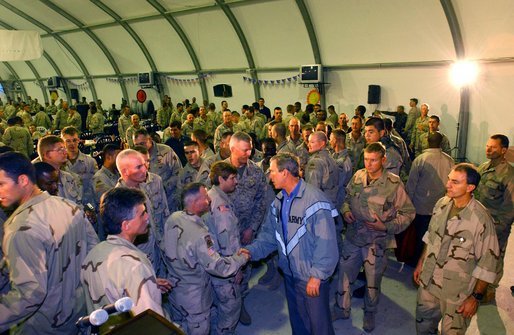 To show his support for America’s troops, President Bush makes a surprise visit to Iraq and shares Thanksgiving Dinner with U.S. troops at the Bob Hope Dining Facility, Baghdad, Iraq, Nov. 27, 2003. White House photo by Tina Hager.
