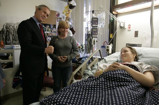 President George W. Bush greets U.S. Army Sgt. Carla Best of Virginia Beach, Va., and her mother Vickie Ebeling during a visit to Walter Reed Army Medical Center in Washington, D.C., Tuesday, Nov. 9, 2004. Sgt. Best sustained injuries while serving in Operation Iraqi Freedom. White House photo by Eric Draper.