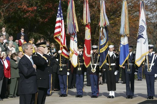 President George W. Bush salutes the playing of the national anthem during a wreath laying ceremony at the Tomb of the Unknowns on Veterans Day Thursday, Nov. 11, 2004. "Today we also recall the men and women who did not live to be called "veterans," many of whom rest in these hills. Our veterans remember the faces and voices of fallen comrades. The families of the lost carry a burden of grief that time will lighten, but never lift," said the President in his remarks. White House photo by Paul Morse