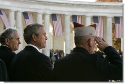 President George W. Bush stands with Secretary of Veterans Affairs Anthony Principi, left, and Mr. Gene Overstreet, President of the Non-Commissioned Officers Association, during the Veterans Day ceremonies at Arlington National Cemetery Nov. 11, 2004. "We honor every soldier, sailor, airman, Marine and Coastguardsman who gave some of the best years of their lives to the service of the United States and stood ready to give life, itself, on our behalf," said the President in his remarks. White House photo by Paul Morse